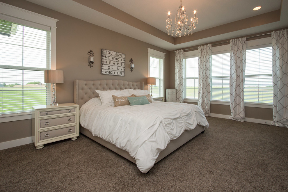 Example of a large beach style master carpeted bedroom design in Other with beige walls and no fireplace