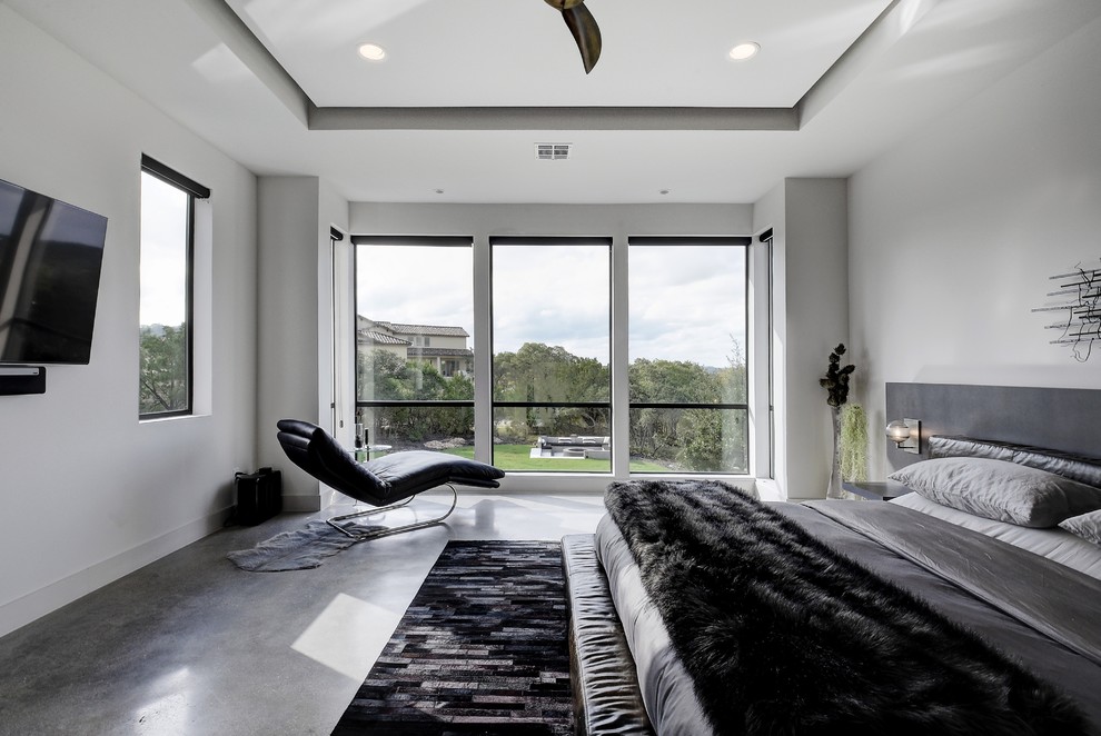 Foto de dormitorio principal contemporáneo grande con paredes blancas, suelo de cemento y suelo gris