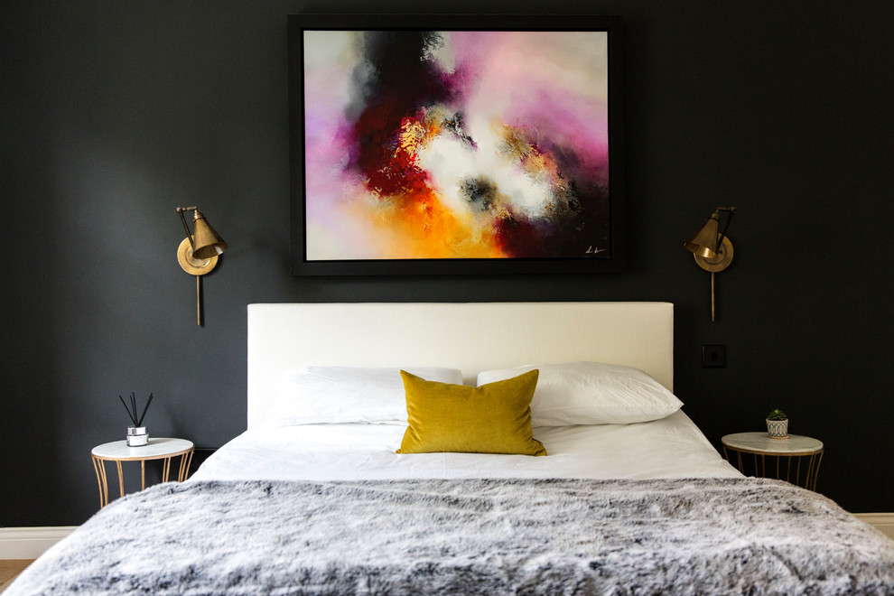 Inspiration for a contemporary master bedroom in London with black walls.