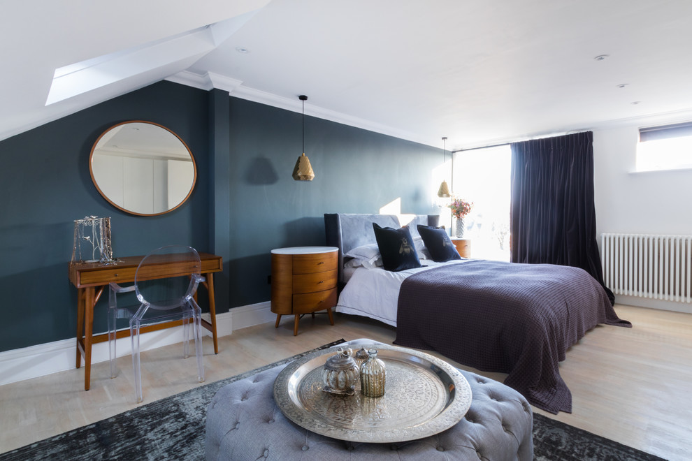 Retro grey and silver bedroom in London with blue walls and light hardwood flooring.
