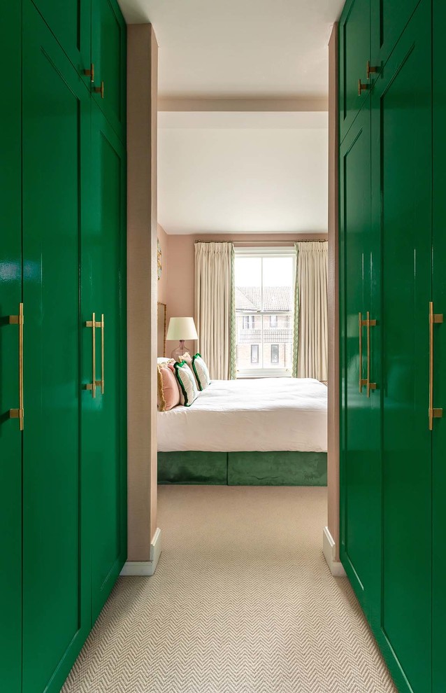 Example of a mid-sized eclectic master carpeted and beige floor bedroom design in London with pink walls