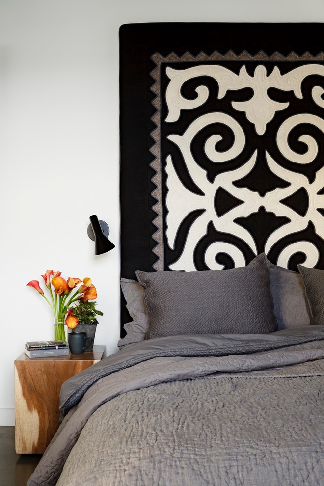 Inspiration for an industrial bedroom remodel in Portland with white walls