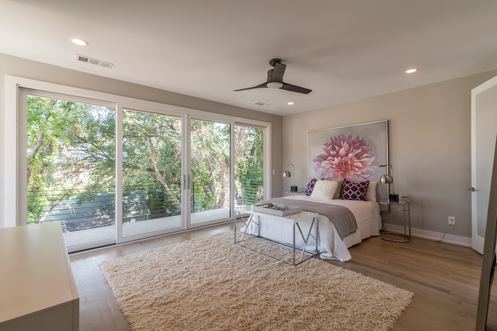 Photo of a medium sized modern master bedroom in Atlanta with grey walls and light hardwood flooring.