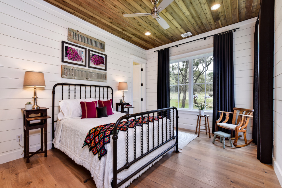 Foto de dormitorio campestre de tamaño medio con paredes blancas, suelo de madera clara y suelo beige