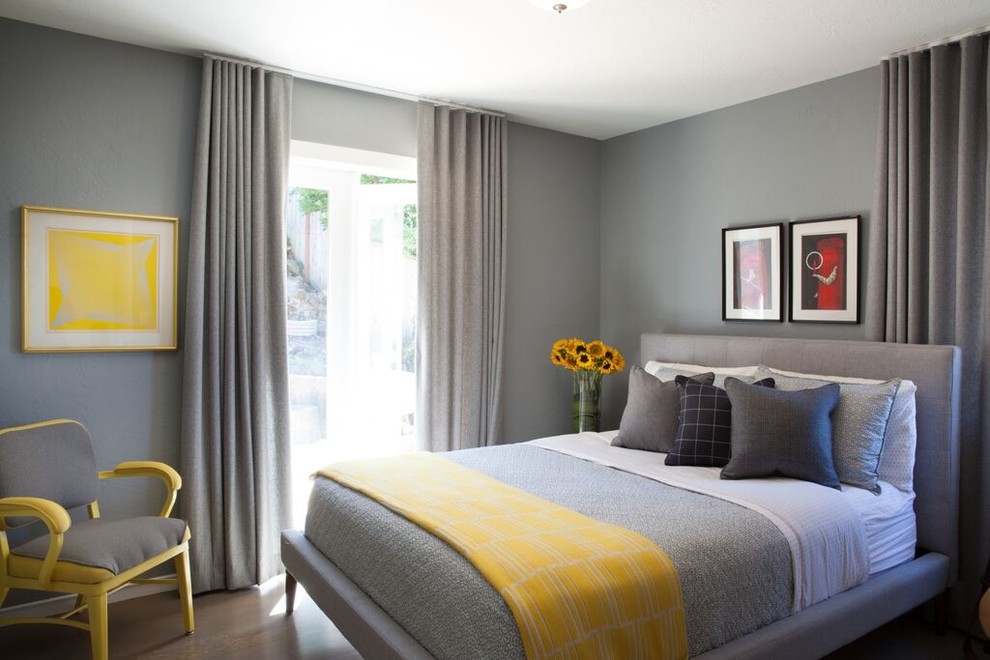 Mid-century modern guest medium tone wood floor bedroom photo in San Francisco with gray walls