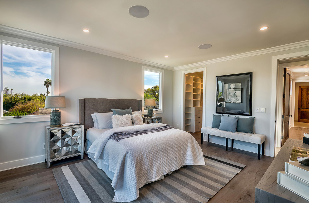 This is an example of a traditional grey and brown bedroom in Los Angeles with grey walls, dark hardwood flooring and brown floors.
