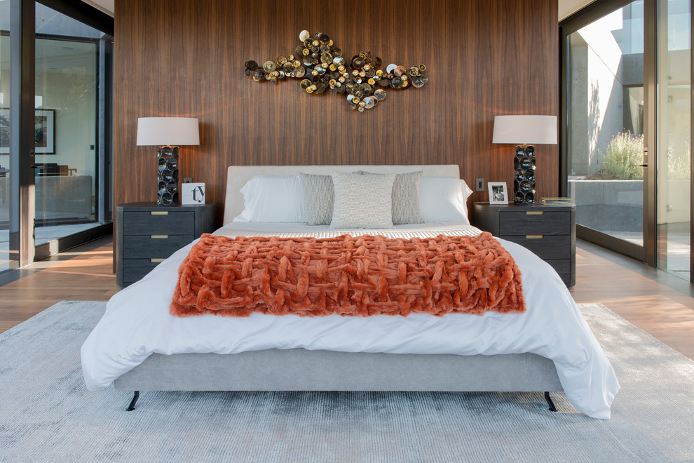 This is an example of a retro grey and brown bedroom in Other with brown walls, medium hardwood flooring and brown floors.