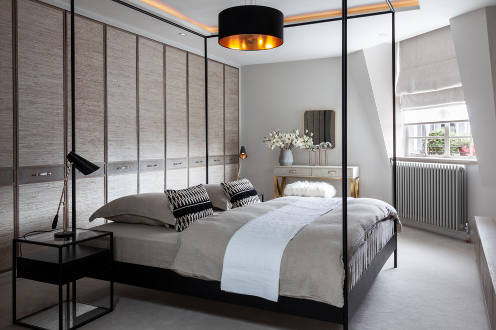 Medium sized contemporary master bedroom in London with grey walls, carpet and grey floors.