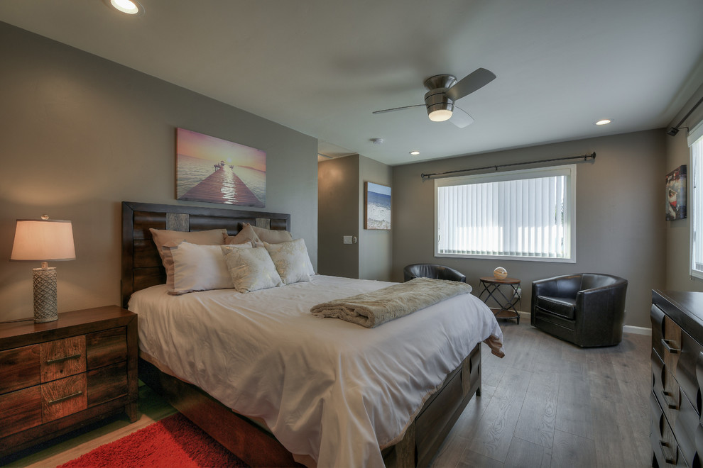 Photo of a medium sized contemporary master bedroom in San Diego with grey walls, light hardwood flooring, no fireplace and grey floors.