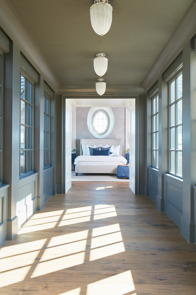 Design ideas for a medium sized beach style master bedroom in Charleston with grey walls and medium hardwood flooring.