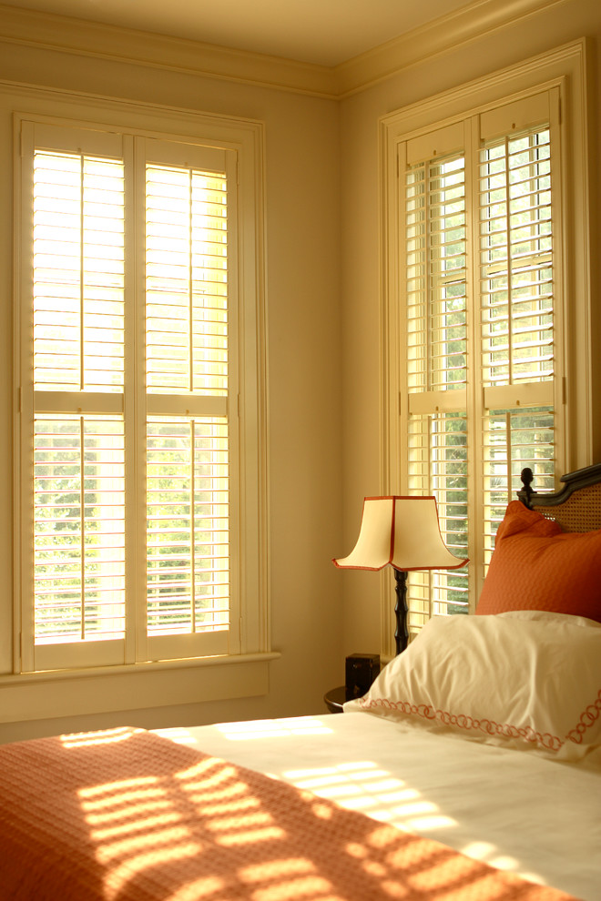 Bedroom - mid-sized coastal guest medium tone wood floor bedroom idea in Charleston with yellow walls