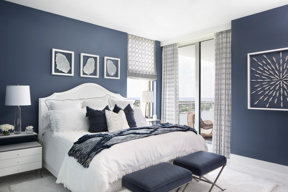 Photo of a beach style bedroom in Miami with blue walls and white floors.