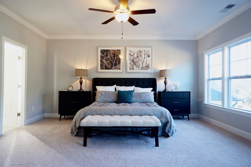 Large contemporary master bedroom in Raleigh with grey walls, carpet and no fireplace.