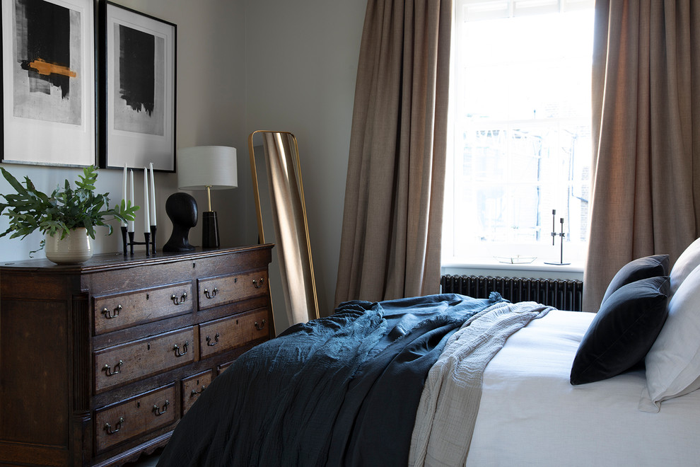 This is an example of a traditional bedroom in London with white walls.