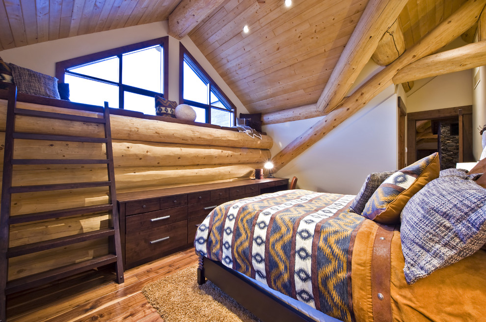 Mountain style medium tone wood floor bedroom photo in Vancouver with white walls