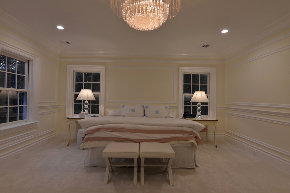 Expansive traditional master bedroom in New York with white walls, carpet, no fireplace and grey floors.