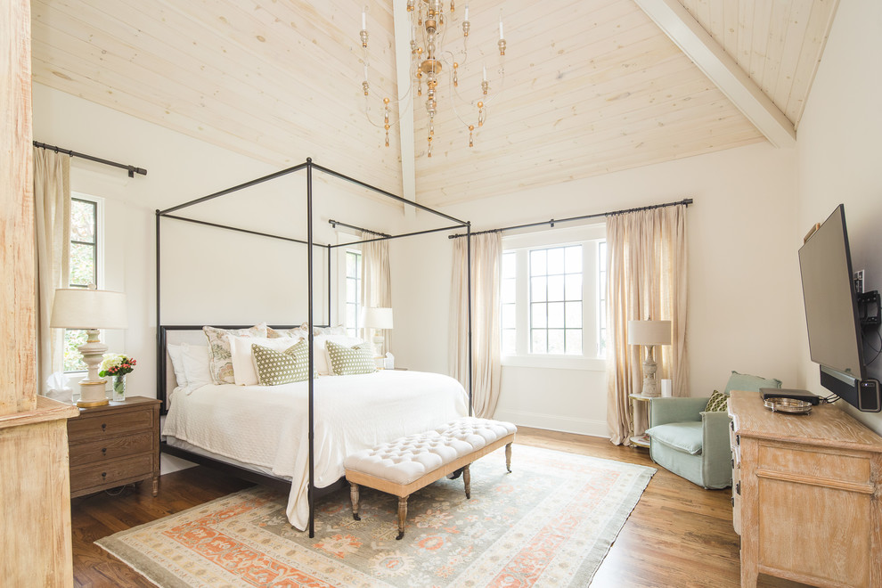 Design ideas for a farmhouse bedroom in Atlanta with white walls, medium hardwood flooring and brown floors.