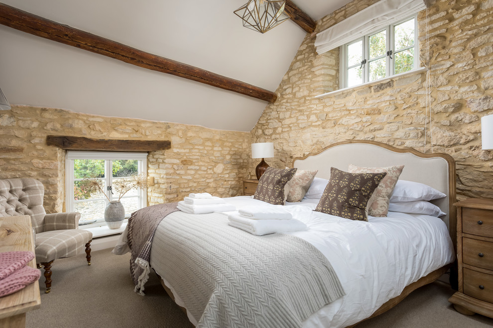 Photo of a medium sized farmhouse guest and grey and brown bedroom in Gloucestershire with beige walls, carpet and beige floors.