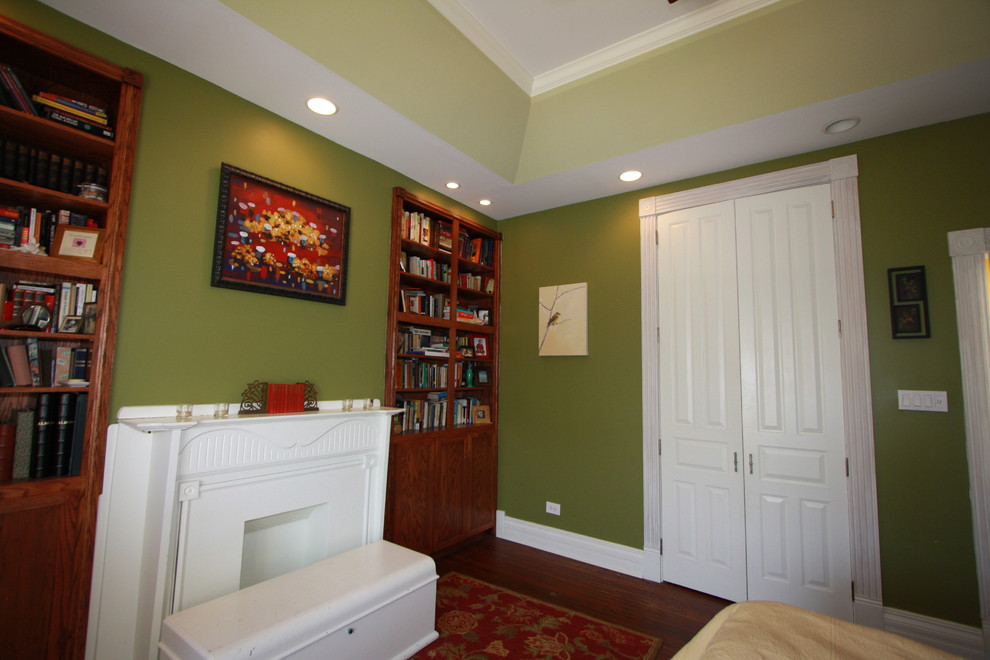 Inspiration pour une chambre avec un mur vert et une cheminée standard.