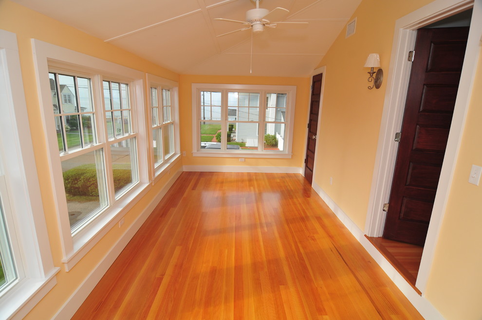 Large elegant loft-style medium tone wood floor bedroom photo in Bridgeport with yellow walls and no fireplace