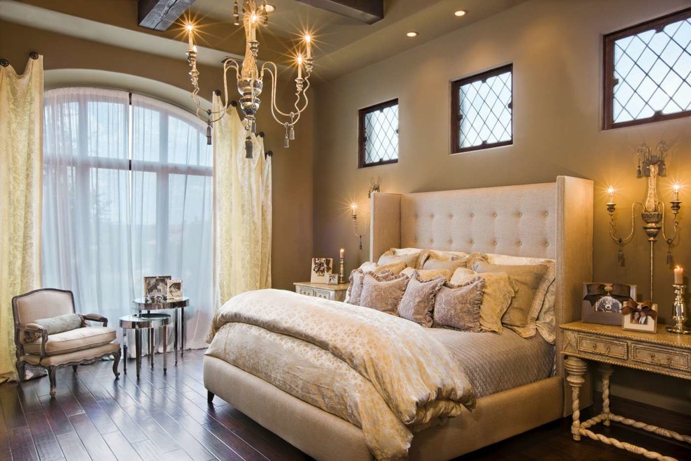 Immagine di una grande camera matrimoniale mediterranea con pareti beige, parquet scuro e pavimento marrone