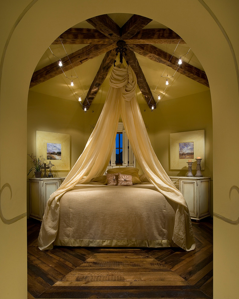 Example of a large classic guest dark wood floor and brown floor bedroom design in Orange County with beige walls