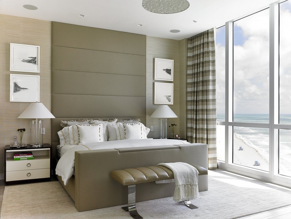 This is an example of a large traditional master bedroom in Miami with beige walls, light hardwood flooring, no fireplace and grey floors.