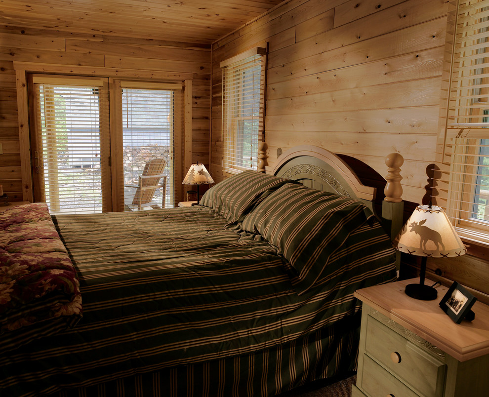 This is an example of a medium sized rustic master bedroom in DC Metro with carpet.