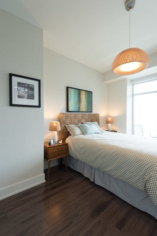 Design ideas for a small contemporary master bedroom in Toronto with white walls and medium hardwood flooring.