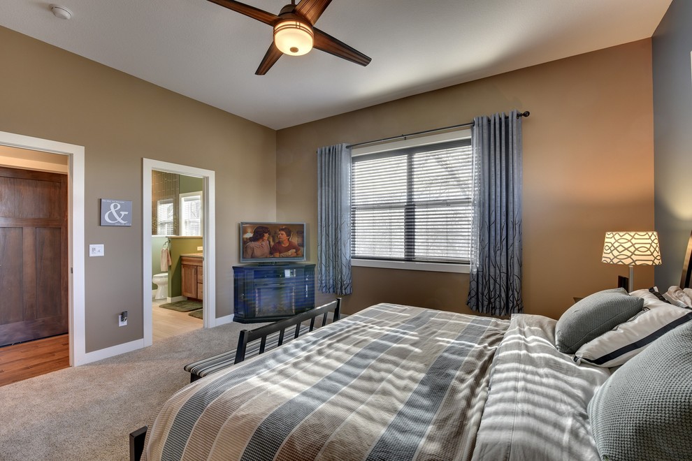 This is an example of a classic master bedroom in Minneapolis with blue walls and carpet.