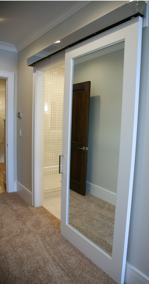 Example of a mid-sized trendy guest carpeted, beige floor and tray ceiling bedroom design in Milwaukee with beige walls