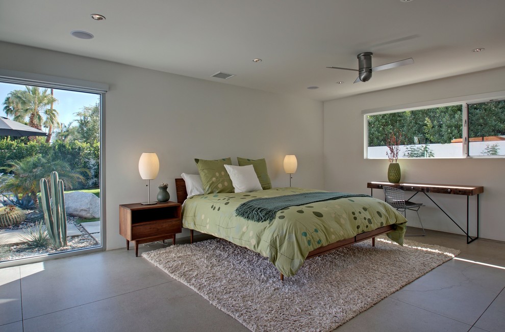 Bedroom - large 1960s guest concrete floor bedroom idea in Los Angeles with white walls