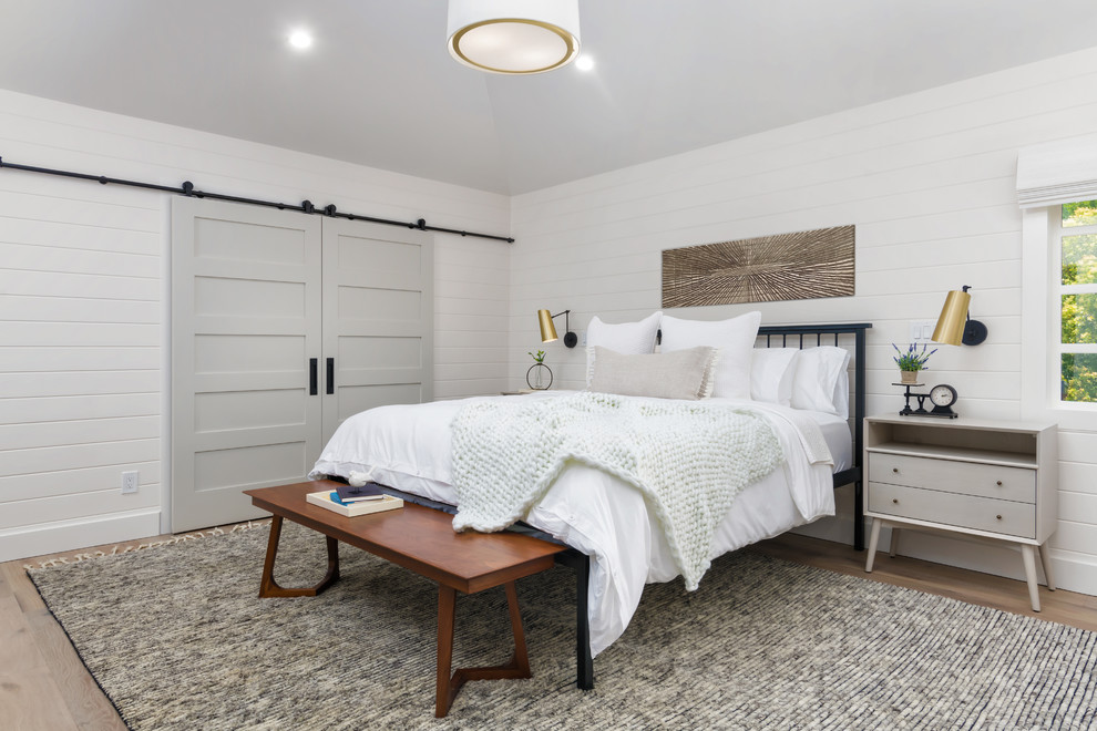 Inspiration for a large country master and grey and brown bedroom in San Francisco with white walls, brown floors and medium hardwood flooring.