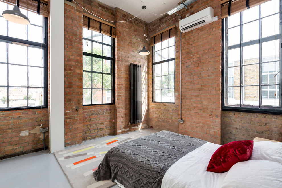 Inspiration for an industrial bedroom in London with no fireplace.