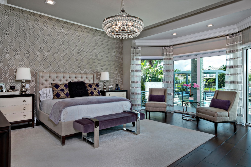 This is an example of a contemporary master and grey and purple bedroom in Miami with beige walls, dark hardwood flooring, brown floors and a feature wall.