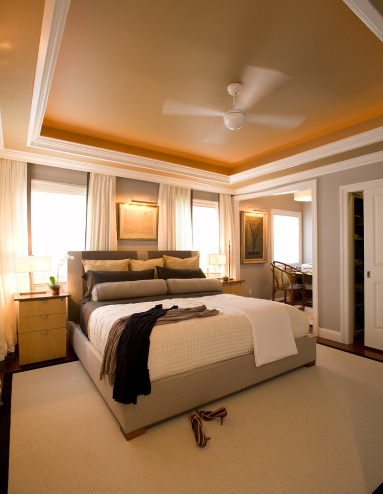 Example of a large transitional master medium tone wood floor bedroom design in New York with gray walls