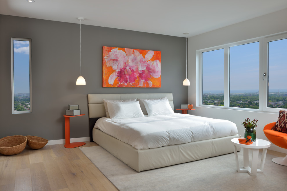 Example of a mid-sized trendy master light wood floor and beige floor bedroom design in Toronto with gray walls