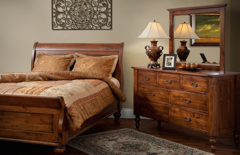 Photo of a medium sized rustic master bedroom in Nashville with beige walls and medium hardwood flooring.