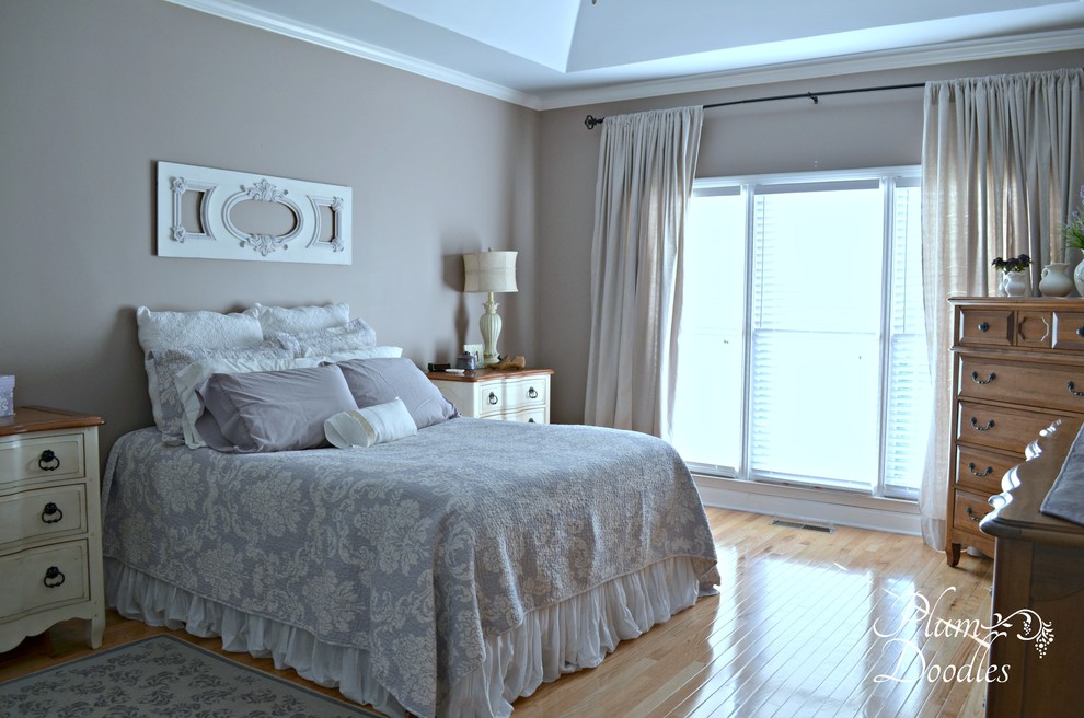 Photo of a medium sized classic master bedroom in Atlanta with beige walls and medium hardwood flooring.