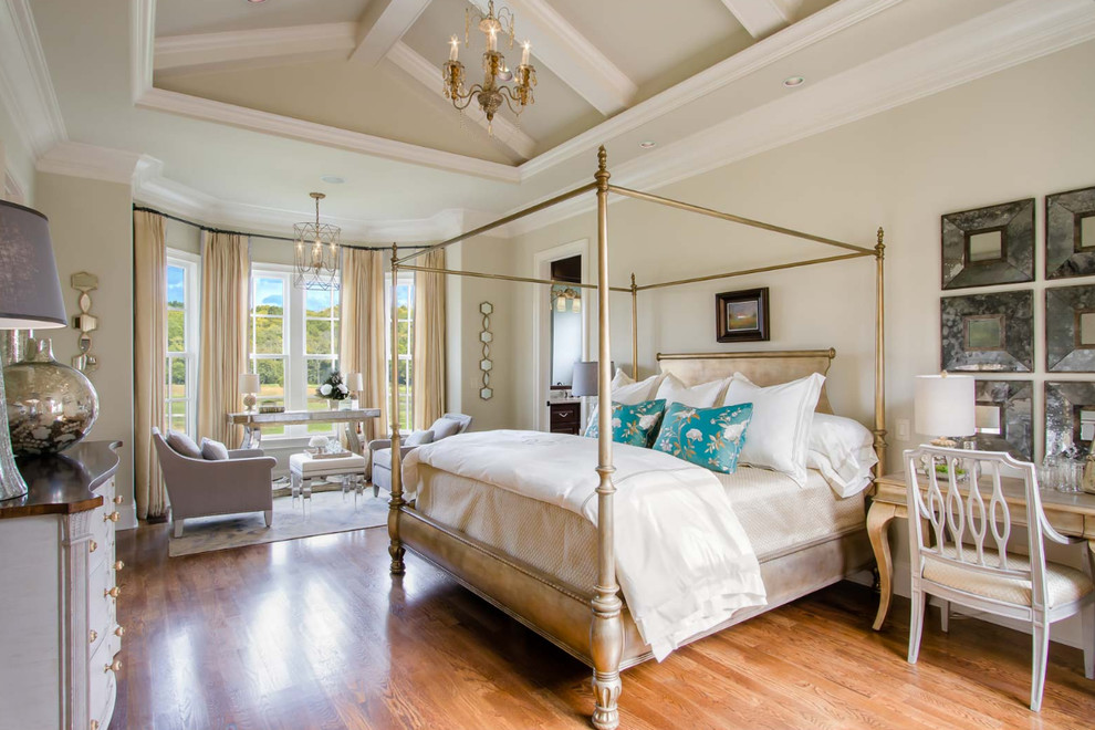Design ideas for a large country master bedroom in Nashville with beige walls, medium hardwood flooring, no fireplace and brown floors.