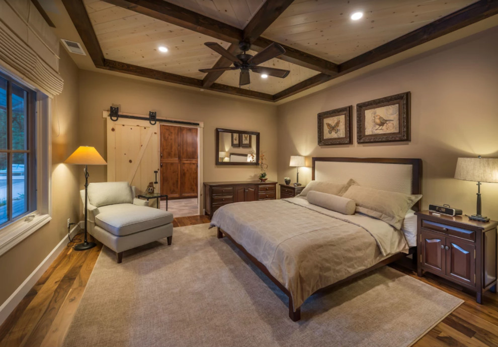 Large cottage master dark wood floor and brown floor bedroom photo in Other with beige walls and no fireplace