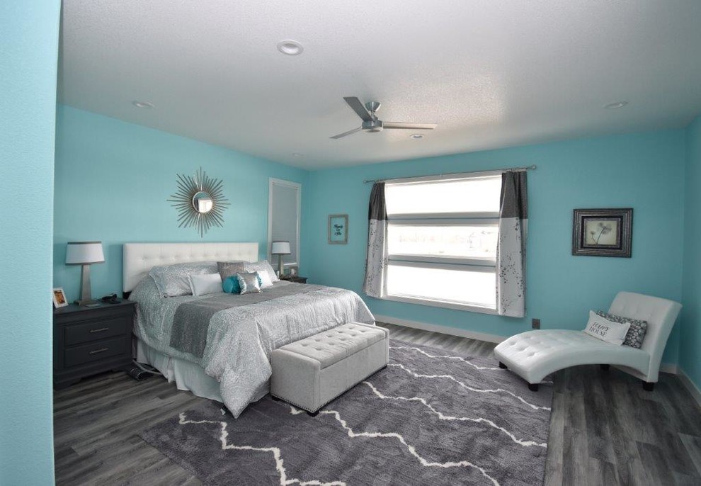 Example of a mid-sized transitional vinyl floor and brown floor bedroom design in Other with blue walls