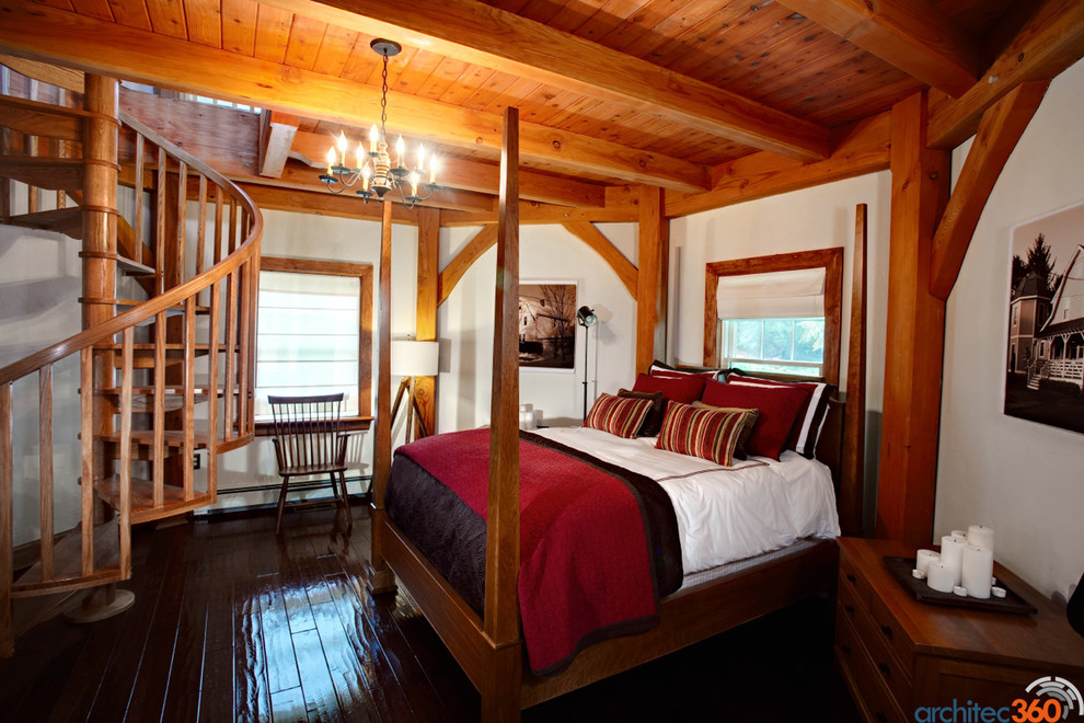 This is an example of a large country bedroom in DC Metro with white walls, dark hardwood flooring and no fireplace.