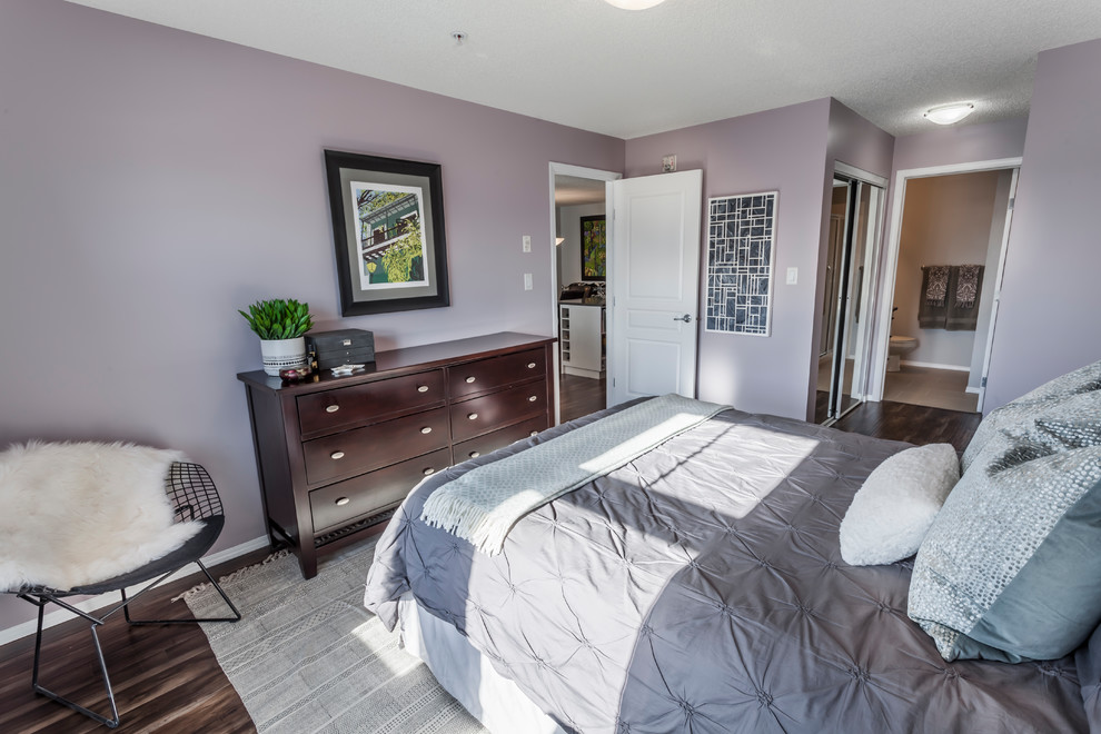 Design ideas for a small traditional master bedroom in Edmonton with purple walls and laminate floors.