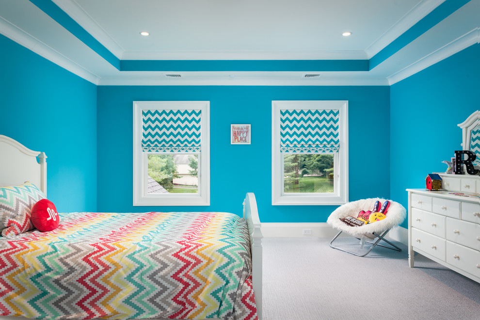Photo of an expansive traditional master bedroom in New York with blue walls, carpet and white floors.