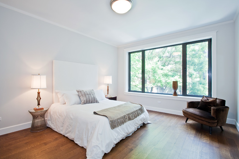 Example of a transitional bedroom design in New York with white walls