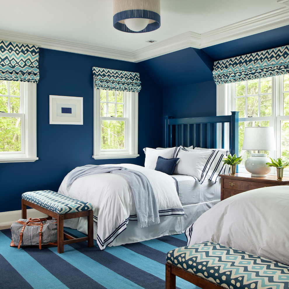 This is an example of a beach style guest bedroom in Boston with blue walls and no fireplace.