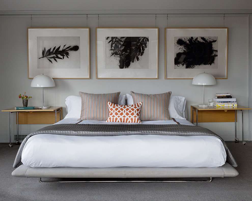 This is an example of a large classic master bedroom in San Francisco with white walls and carpet.