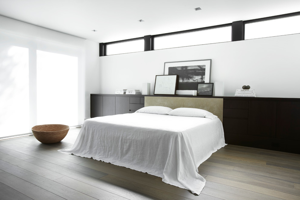 Photo of a contemporary bedroom in San Francisco with white walls, dark hardwood flooring and no fireplace.