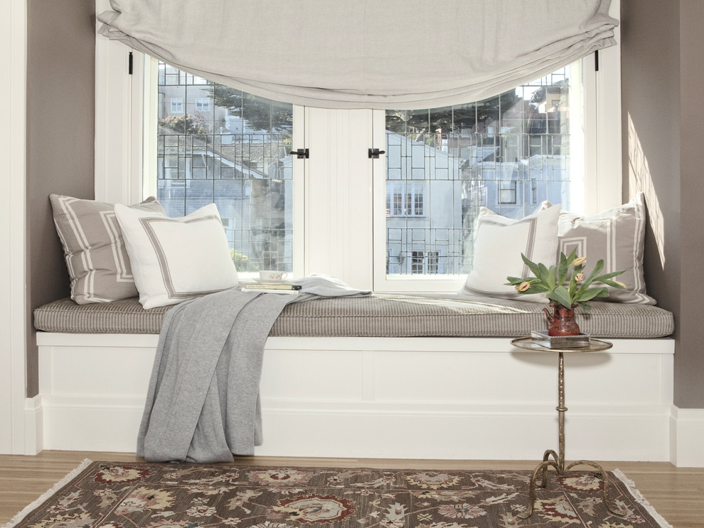 Small elegant master medium tone wood floor bedroom photo in San Francisco with brown walls